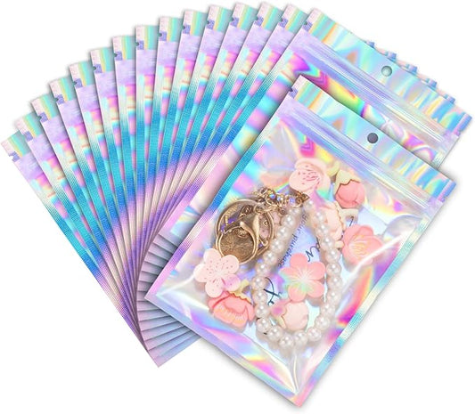 ANZNKU 100 Pack Mylar Bags Reasealable Holographic Bags, Smell Proof Bag Zipper Pouches with Clear Window, Jewelry Candy Sealable Bag for Packaging Sample Party Favor(7.1 x 10.2 Inch)